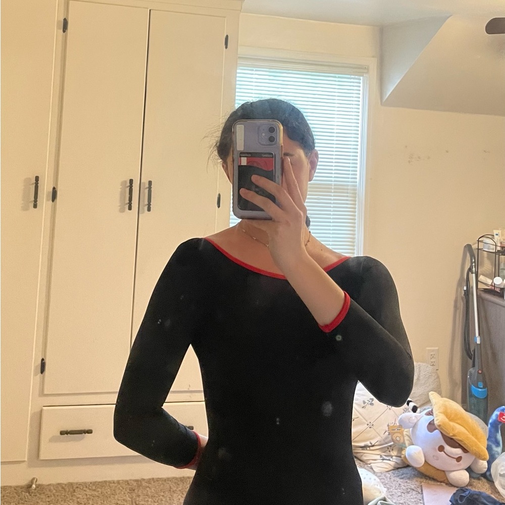 Black mariia leotard with 3/4 sleeves, open back, and red trim